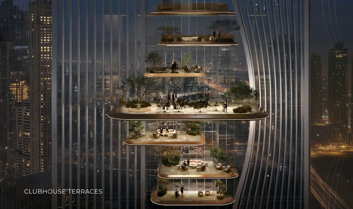 Night view of stacked clubhouse terraces with trees, lit within the tower facade at Ellington Berkeley Tower
