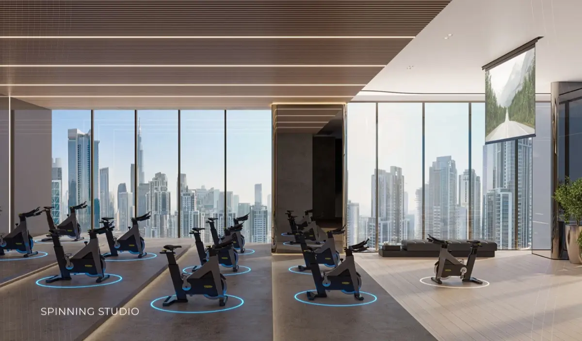 Spinning studio with bikes facing full-height windows at Ellington Berkeley Tower